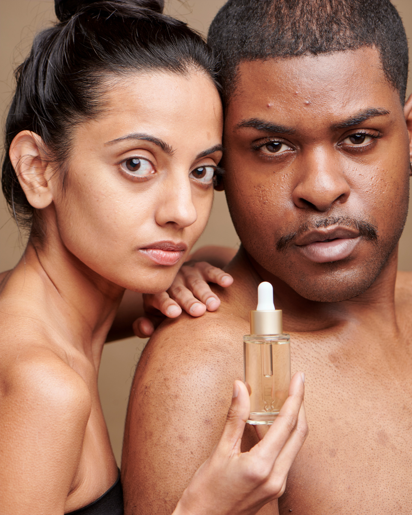 Bare Faces of Man and Woman with Bottle of Serum